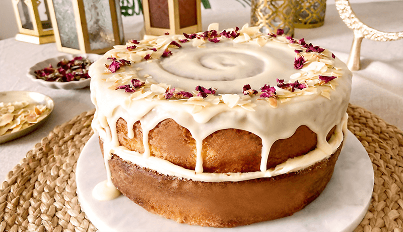 cardamom and almonds cake topped with buttercream and rose petals